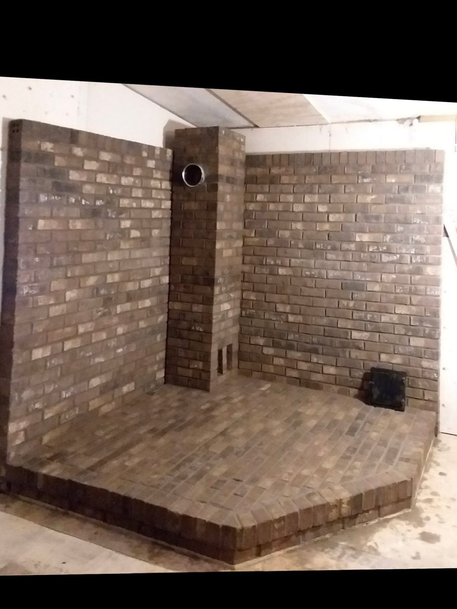 Custom interior brick masonry construction showing bricked walls, floor, and column