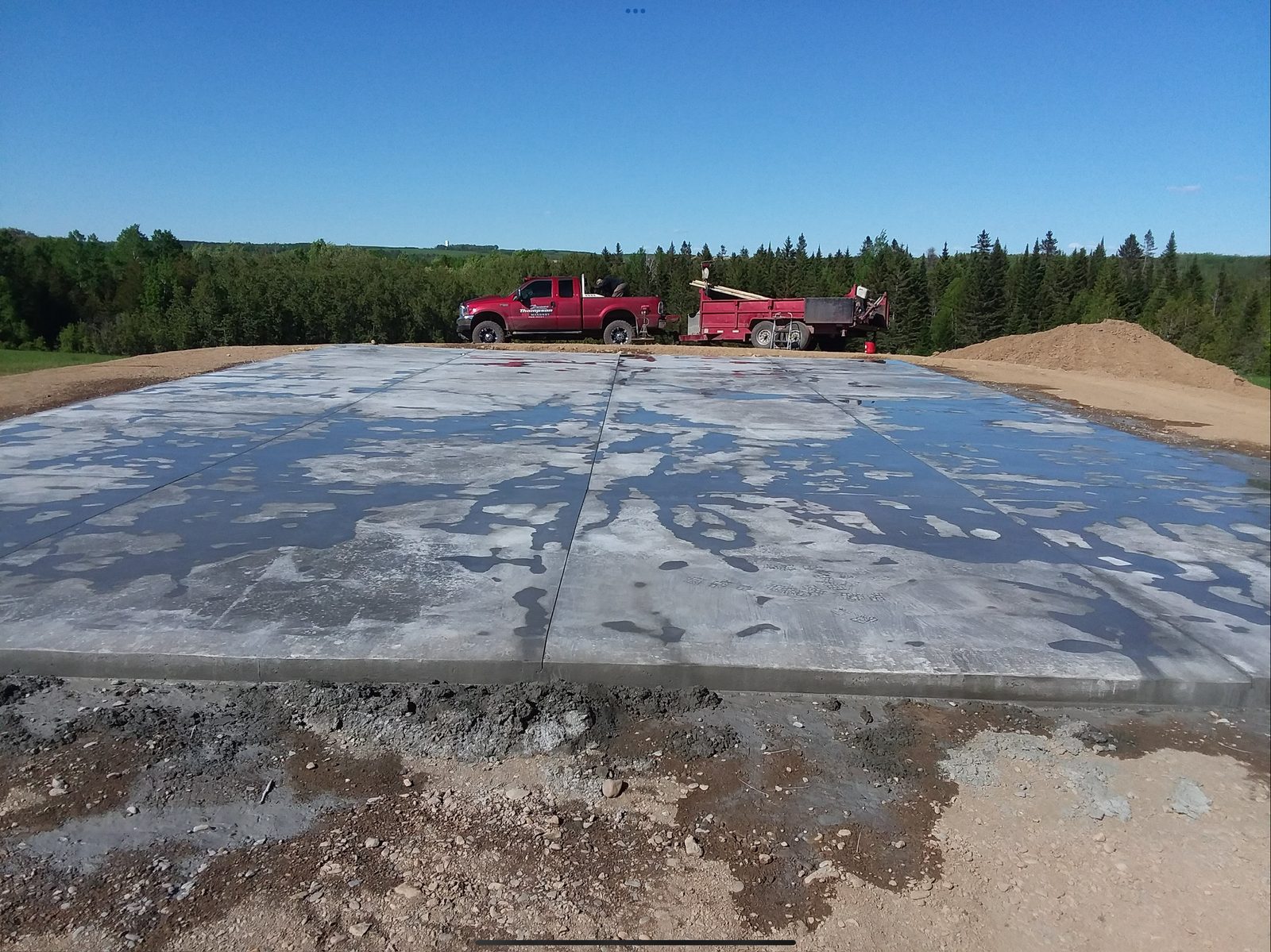 Large concrete slab being poured and finished
