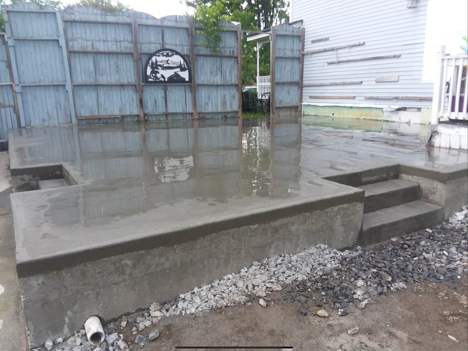 Concrete patio with steps after rain